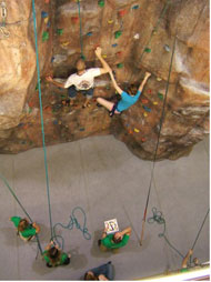Climbers playing Twister on the climbing wall
